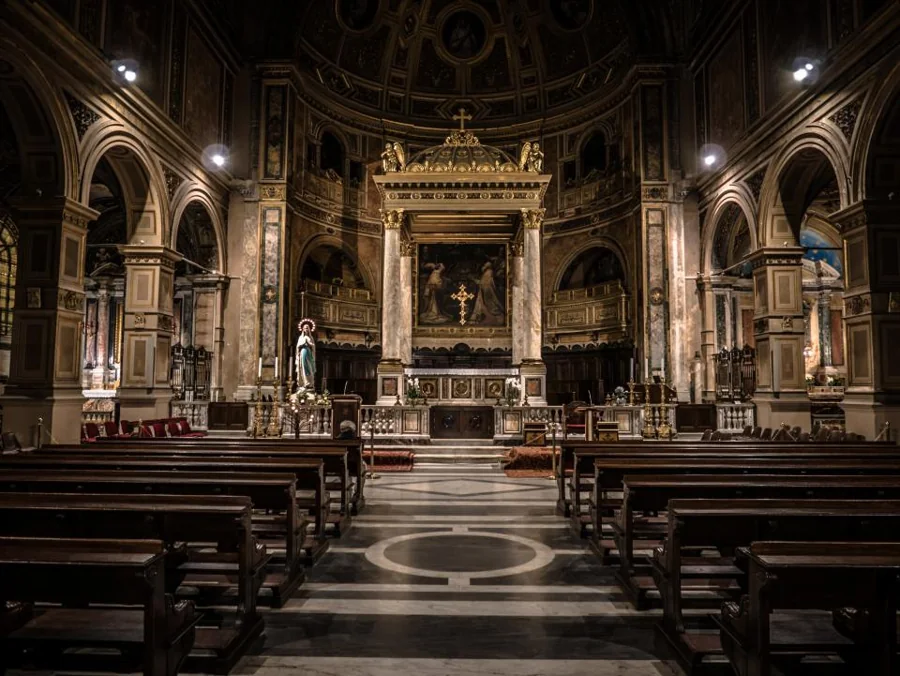 Interior de uma igreja com altar e imagens ao fundo